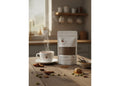 Tea bag and steaming cup on a wooden table with a cozy background