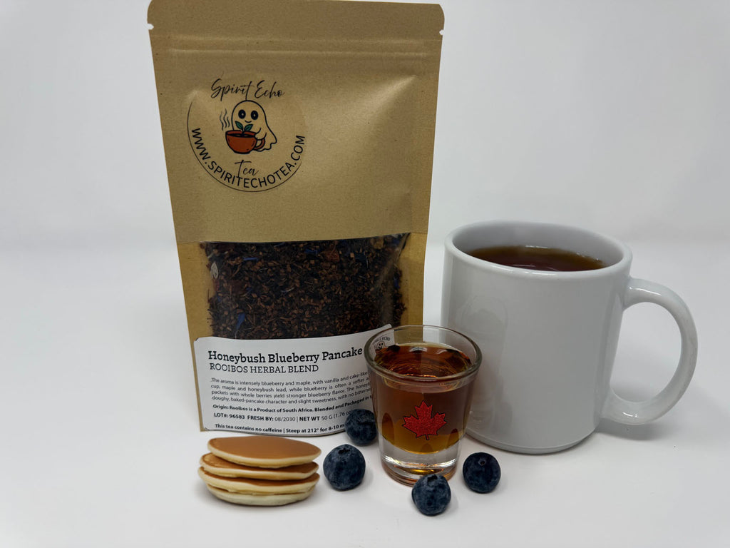 Tea package with a mug of tea, pancakes, and syrup on a white background