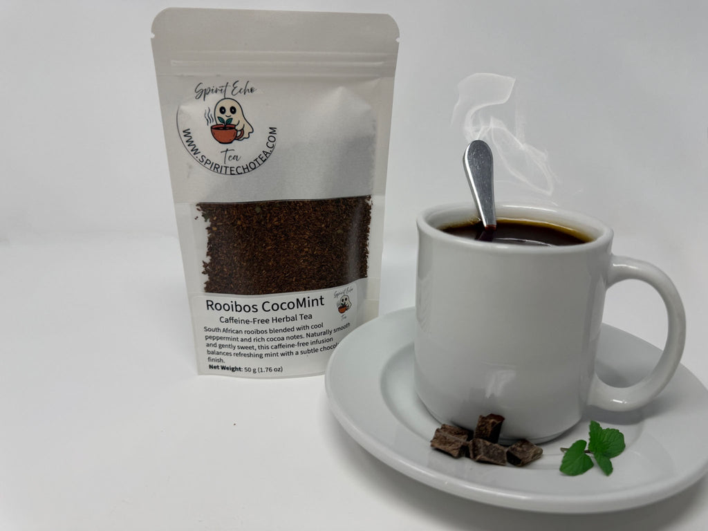 White mug with coffee and a spoon, next to a package of Rooibos CoCoMint tea on a white background