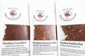 Three packages of Spirit Echo Tea with visible tea samples and branding.