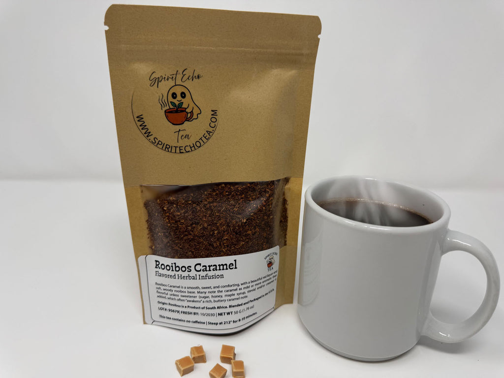Brown Tea Bag 50 Gram Rooibos Caramel with white steaming cup and caramel chunks.