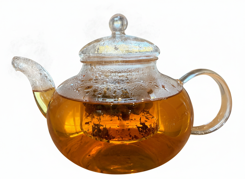 Clear glass teapot with a handle filled with tea on a white background